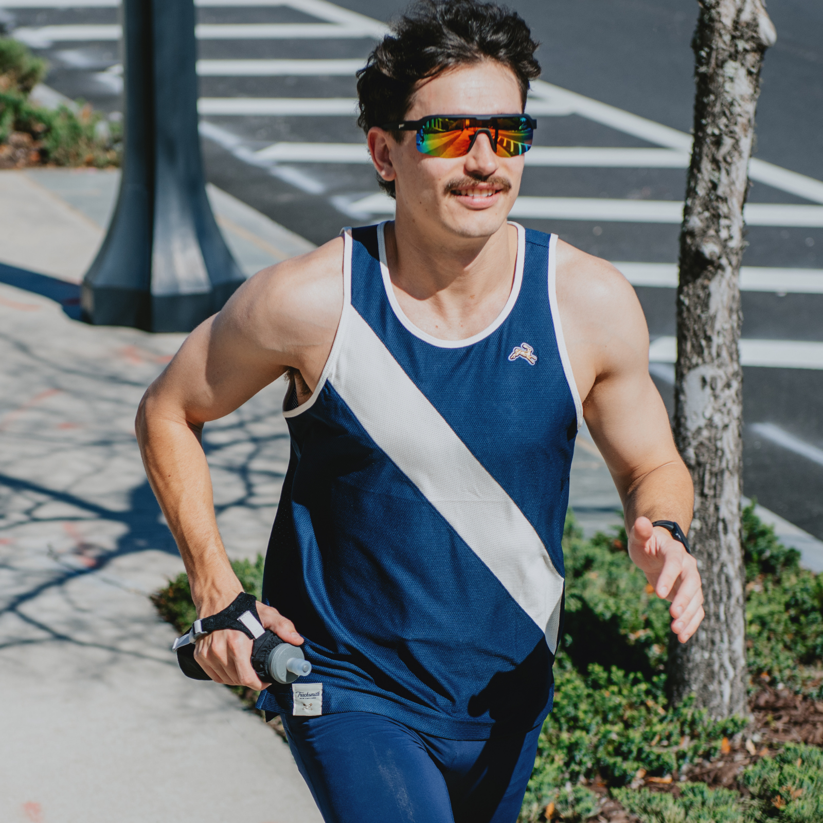 Man wearing a tank top running outside