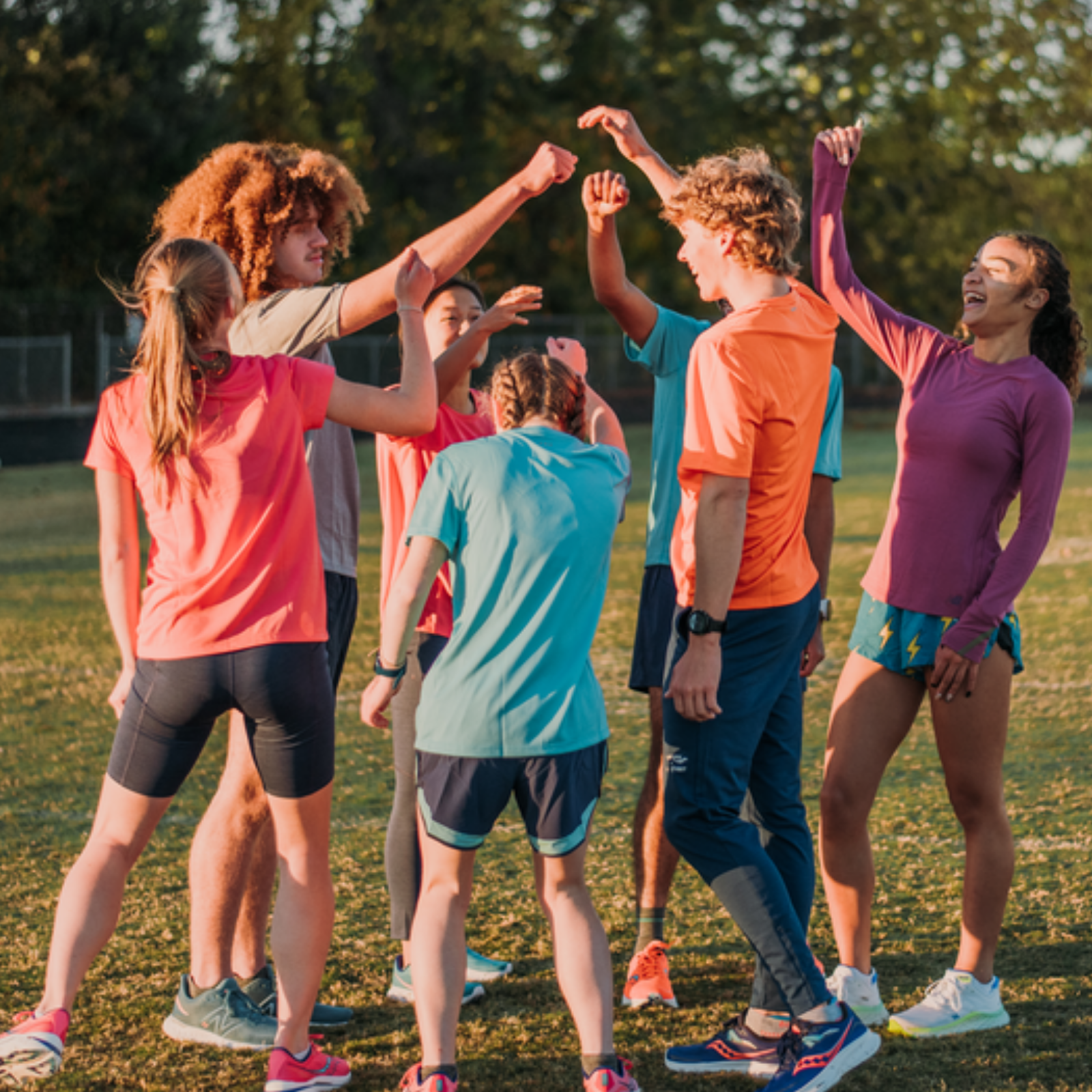 A group of young runners high fiving