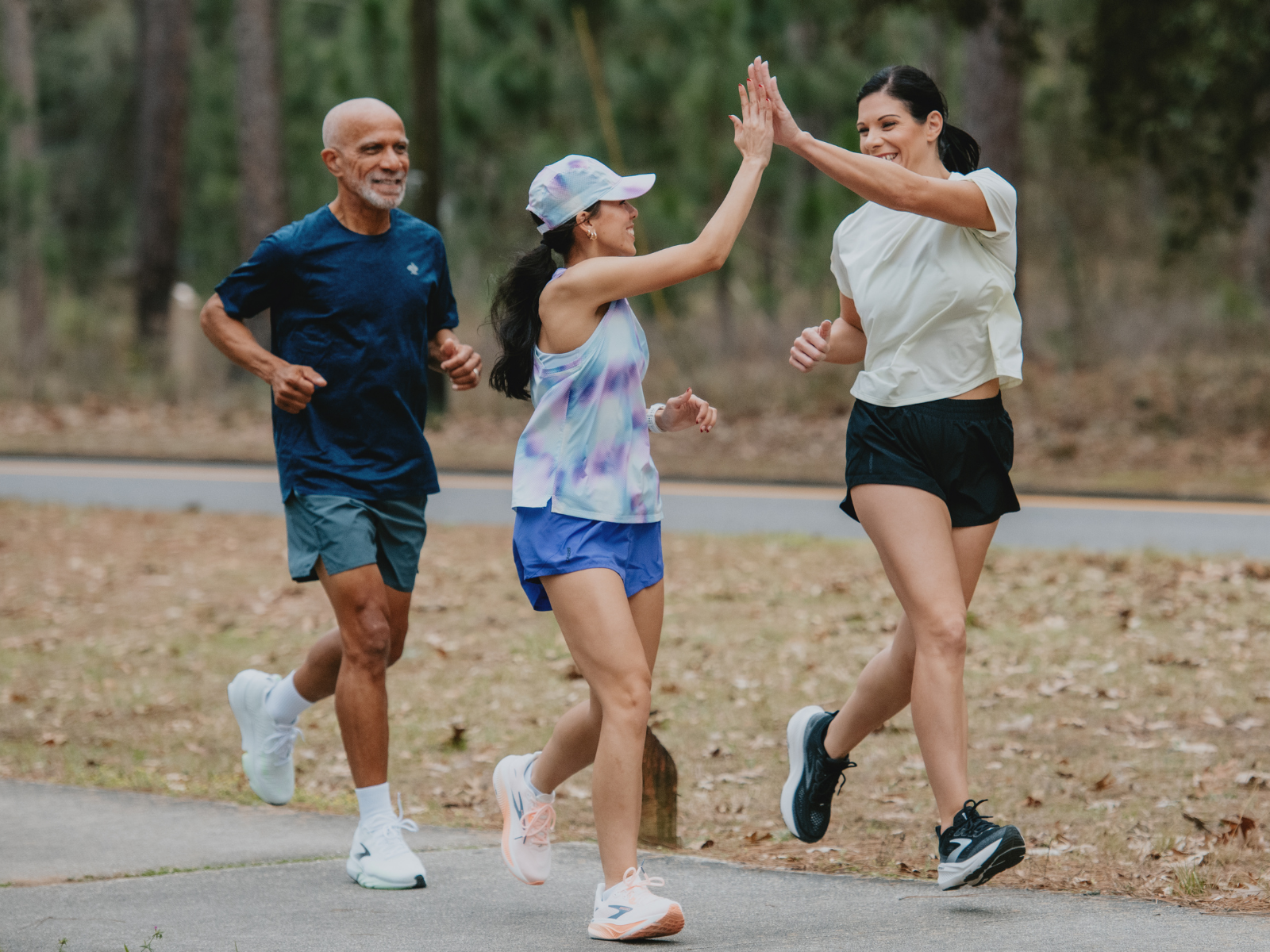 Runners high-fiving and wearing Brooks