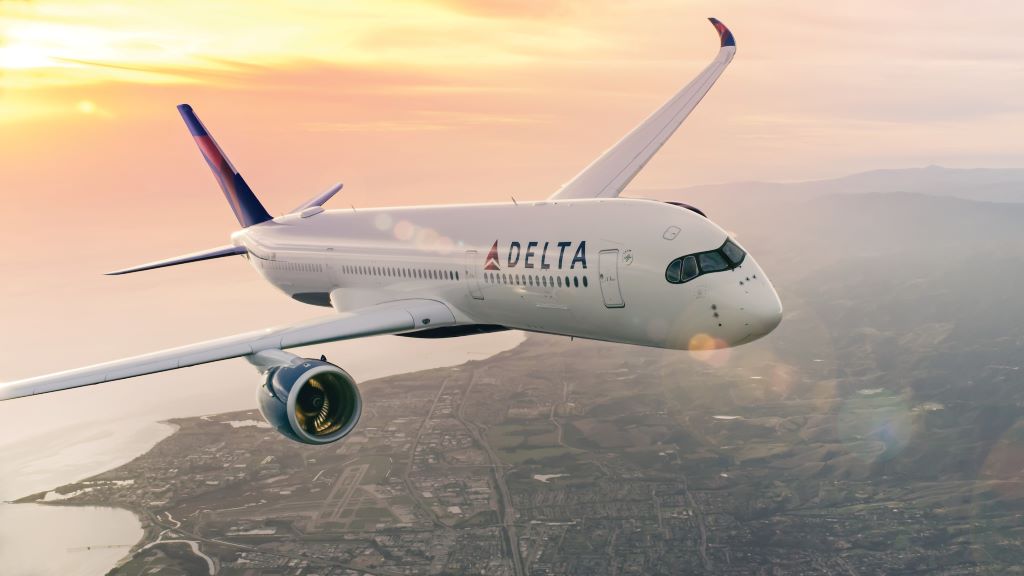 A Delta plane flies over a city