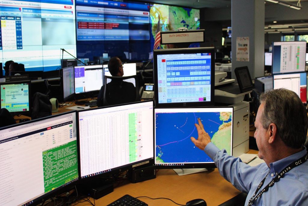 A Duty Director at Delta's Operations & Customer Center sits in front of screens.