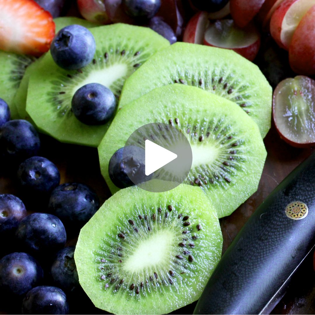 F.N. Sharp Utility Knife with sliced kiwi, strawberries and blueberries