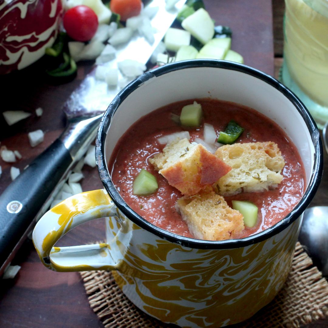 Mug of gazpacho soup with F.N. Sharp Utility Knife and chopped veggies