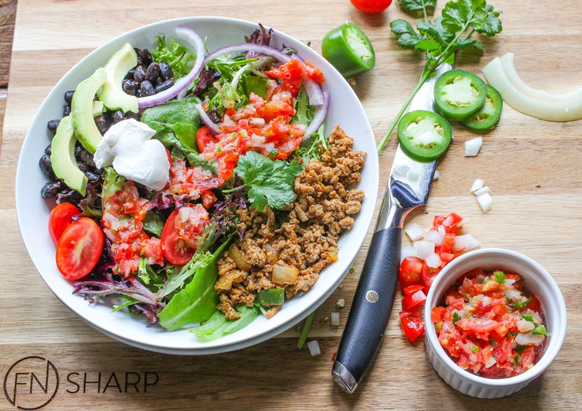 F.N. Sharp Utility Knife With Plated Taco Salad and Ingredients