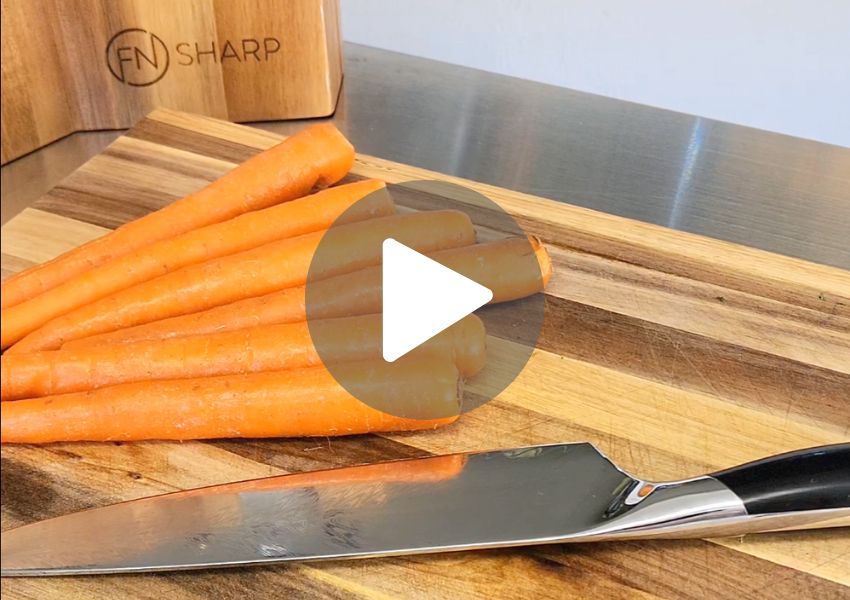 F.N. Sharp Chef's Knife with carrots on acacia wood cutting Board
