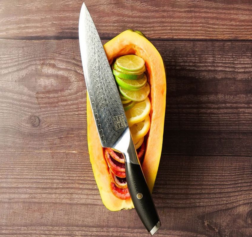 F.N. Sharp Chef's Knife with papaya boat full of sliced fruit