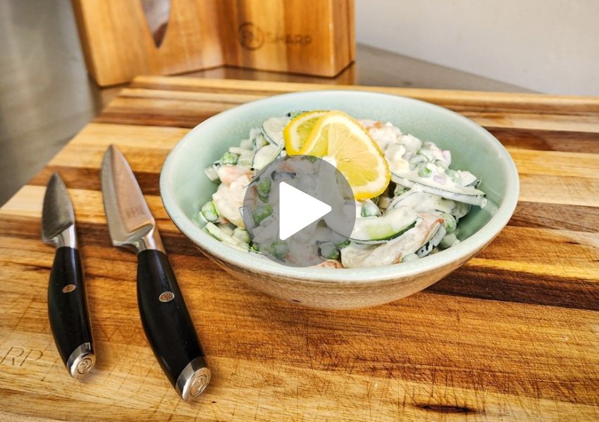 F.N. Sharp Utility & Paring Knives on cutting board with creamy cucumber salad