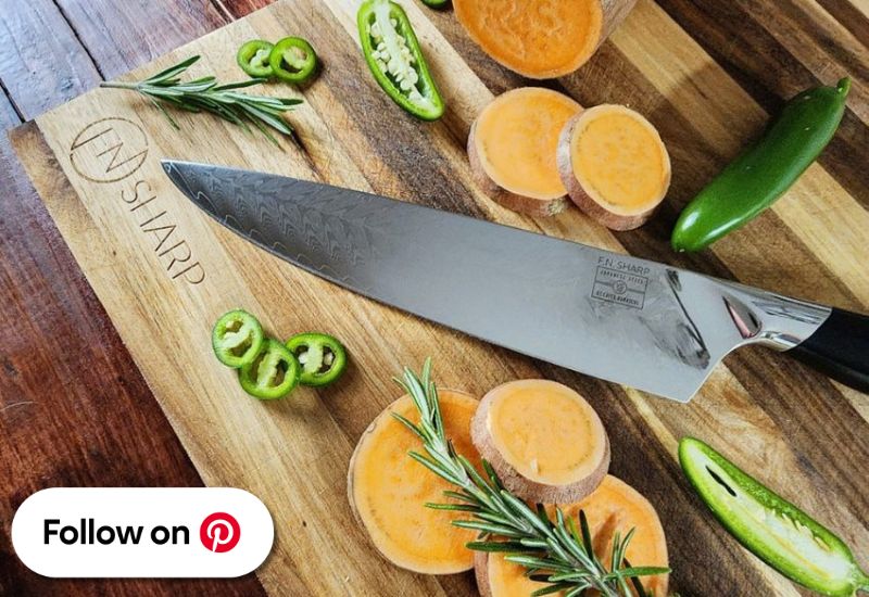 F.N. Sharp Chef's Knife on Acacia wood cutting board with assorted veggies