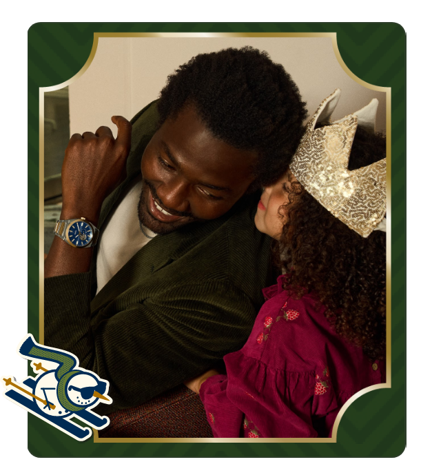 Father wearing a Fossil watch sharing a special holiday moment with his daughter.