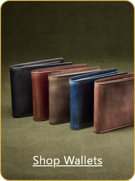 Image of multiple mens leather wallets in various colors with on-image text that reads 'Shop Wallets'.
