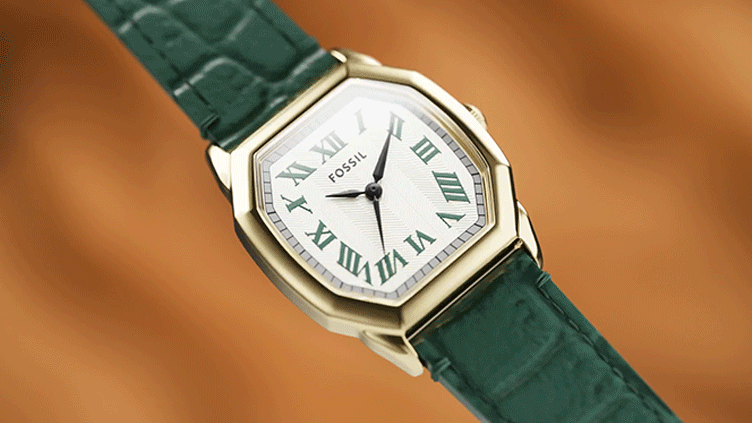 GIF of green croc leather watch with gold case and textured dial, rotating to show engraved backs reading “Sleigh” and “Cookie Queen.