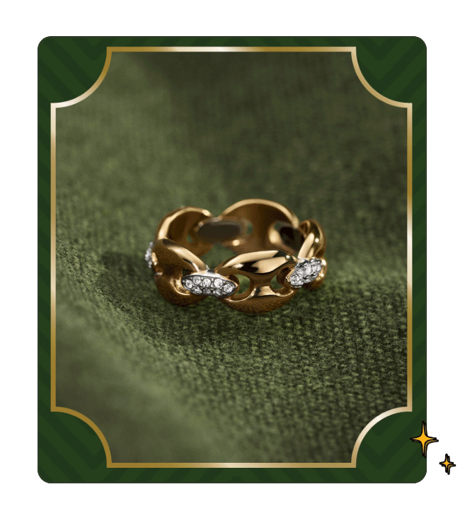 GIF of pavé crystal and gold link ring closeup against a dark green seasonal background