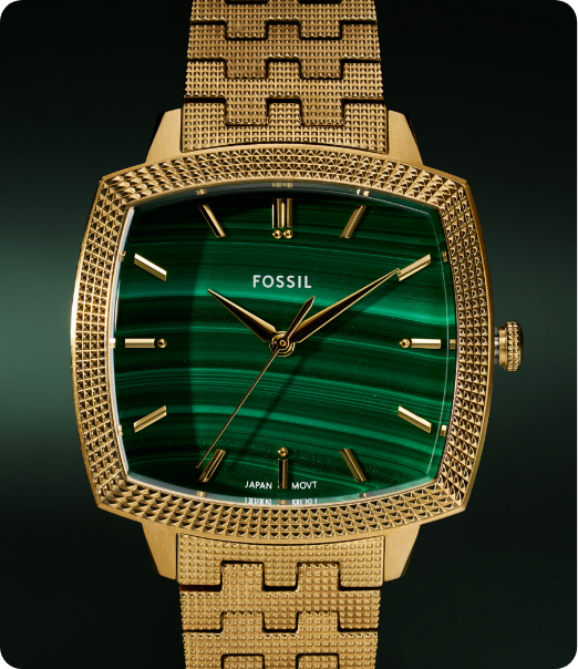 Close-up of Fossil men’s 18k gold watch with green malachite dial and gold band