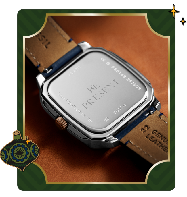 Close-up of back of a Fossil watch with leather straps and an engraving that reads  ‘be present”