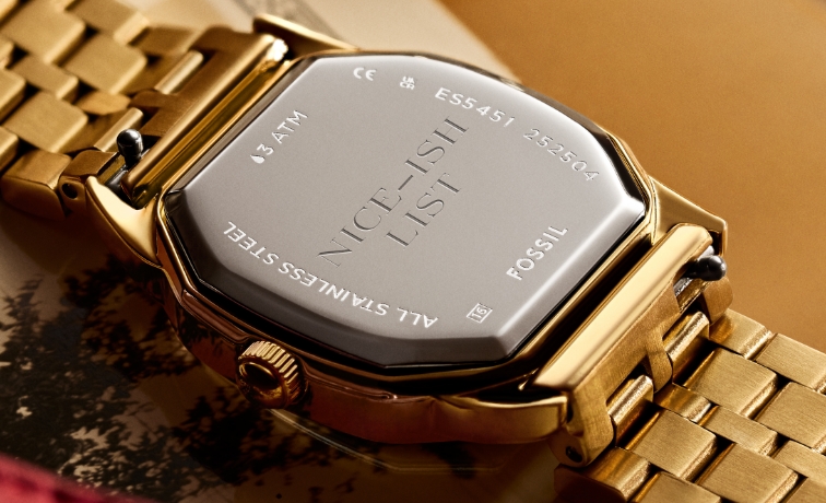 A close-up of back of watch with an engraving Nice-ish List