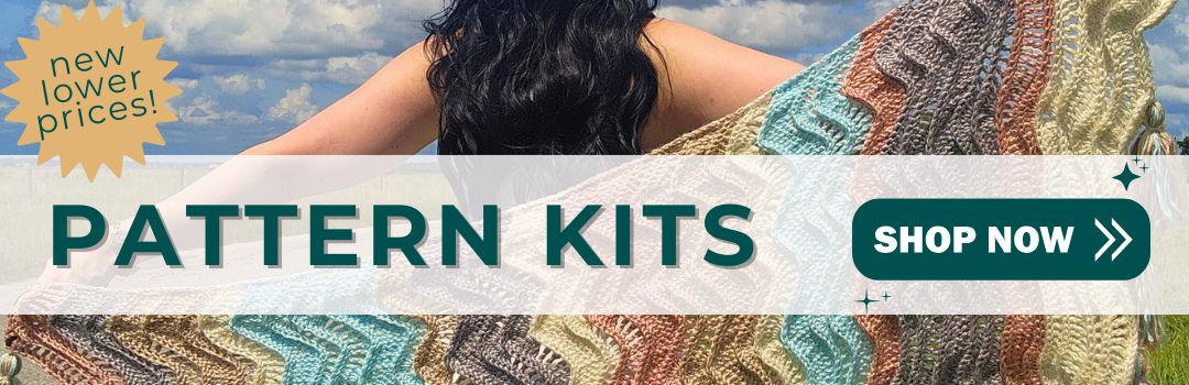 New lower prices - pattern kits - shop now. Image: woman holding a crochet shawl