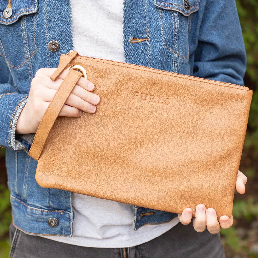 Person holding a Saddle Tan Blair Clutch