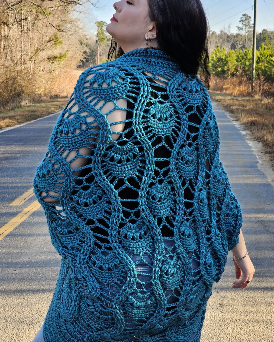 Journey Chanel wearing a blue pineapple crochet shrug