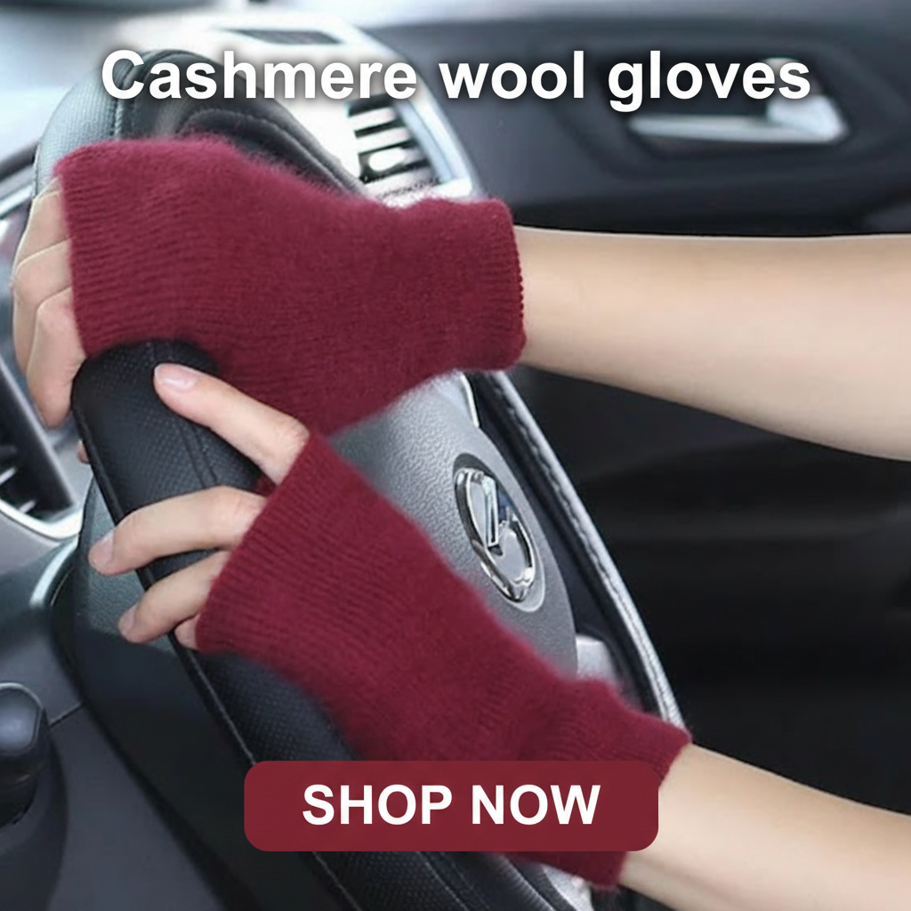 Hands wearing maroon cashmere fingerless gloves on a car steering wheel.