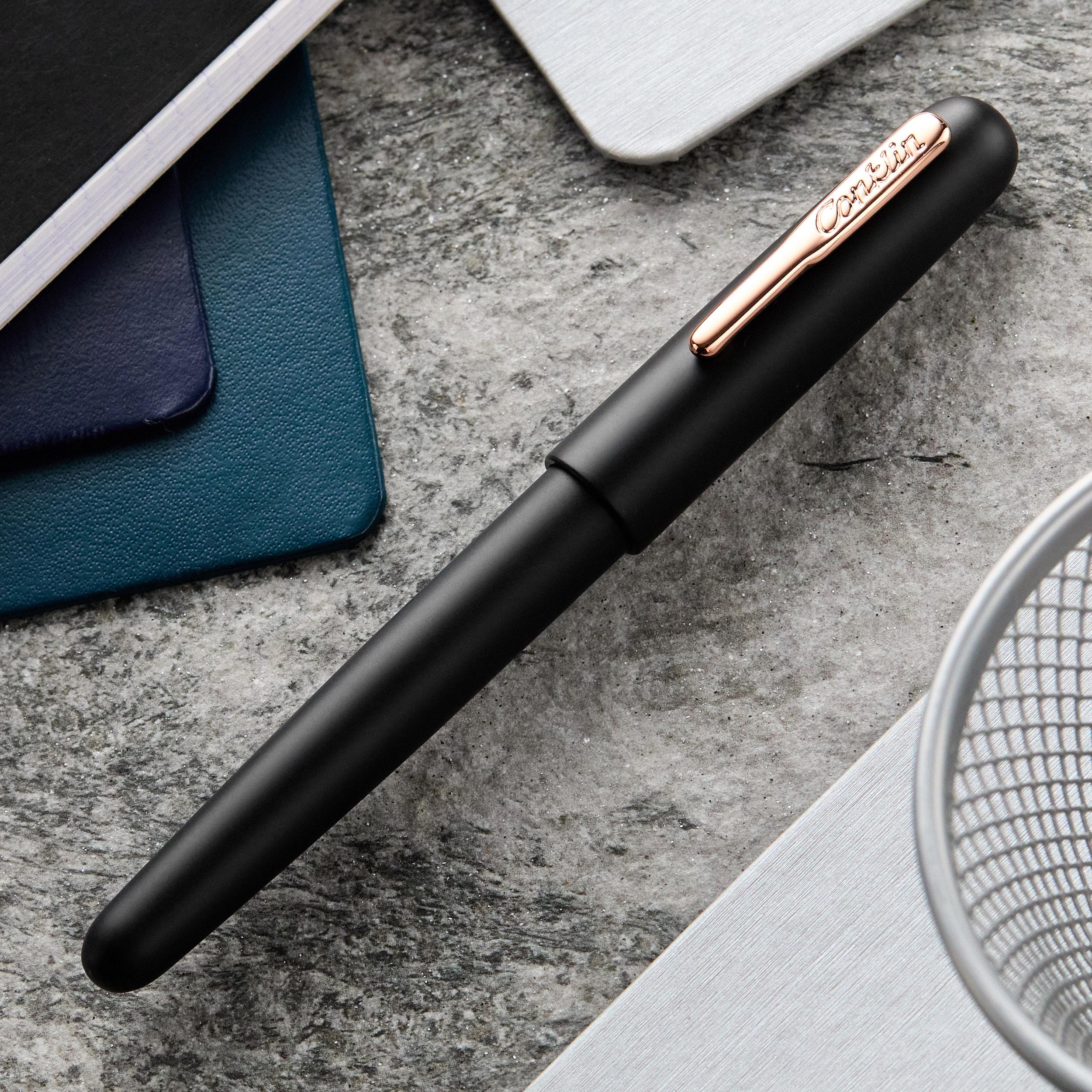 an image of a pen and a notebook on a table