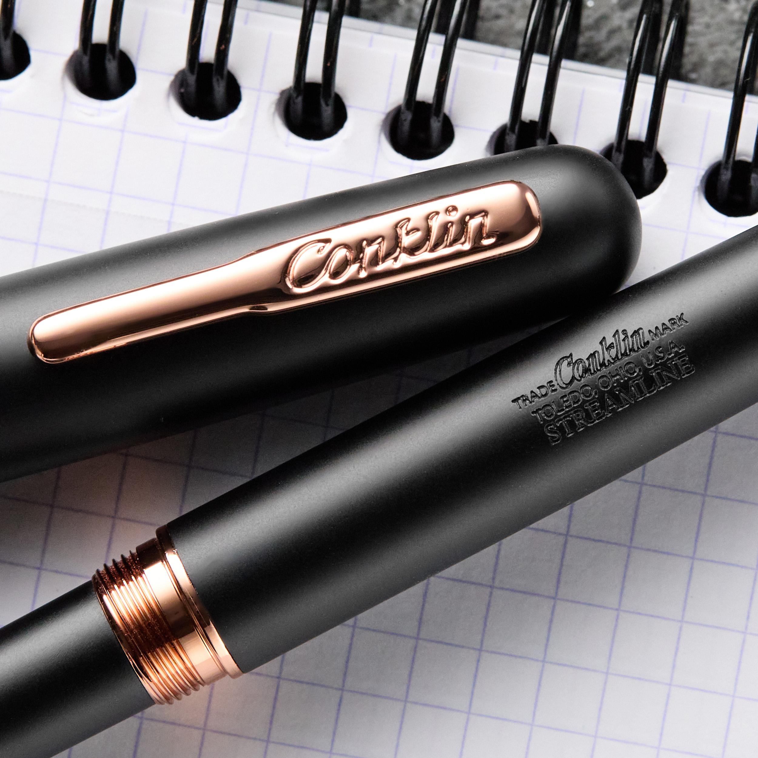 an image of a pen and a notebook with a pen tip