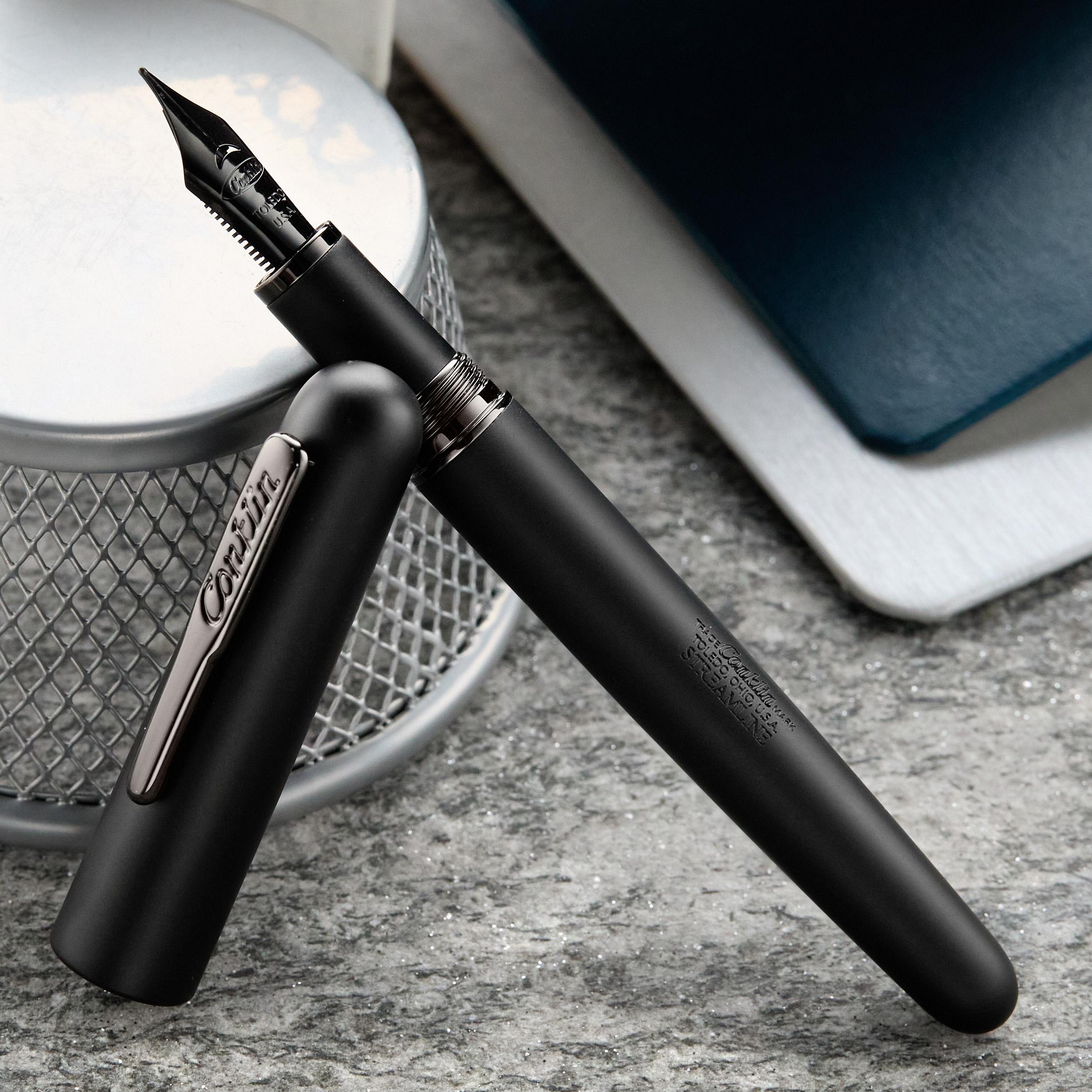 an image of a pen and a notebook on a table