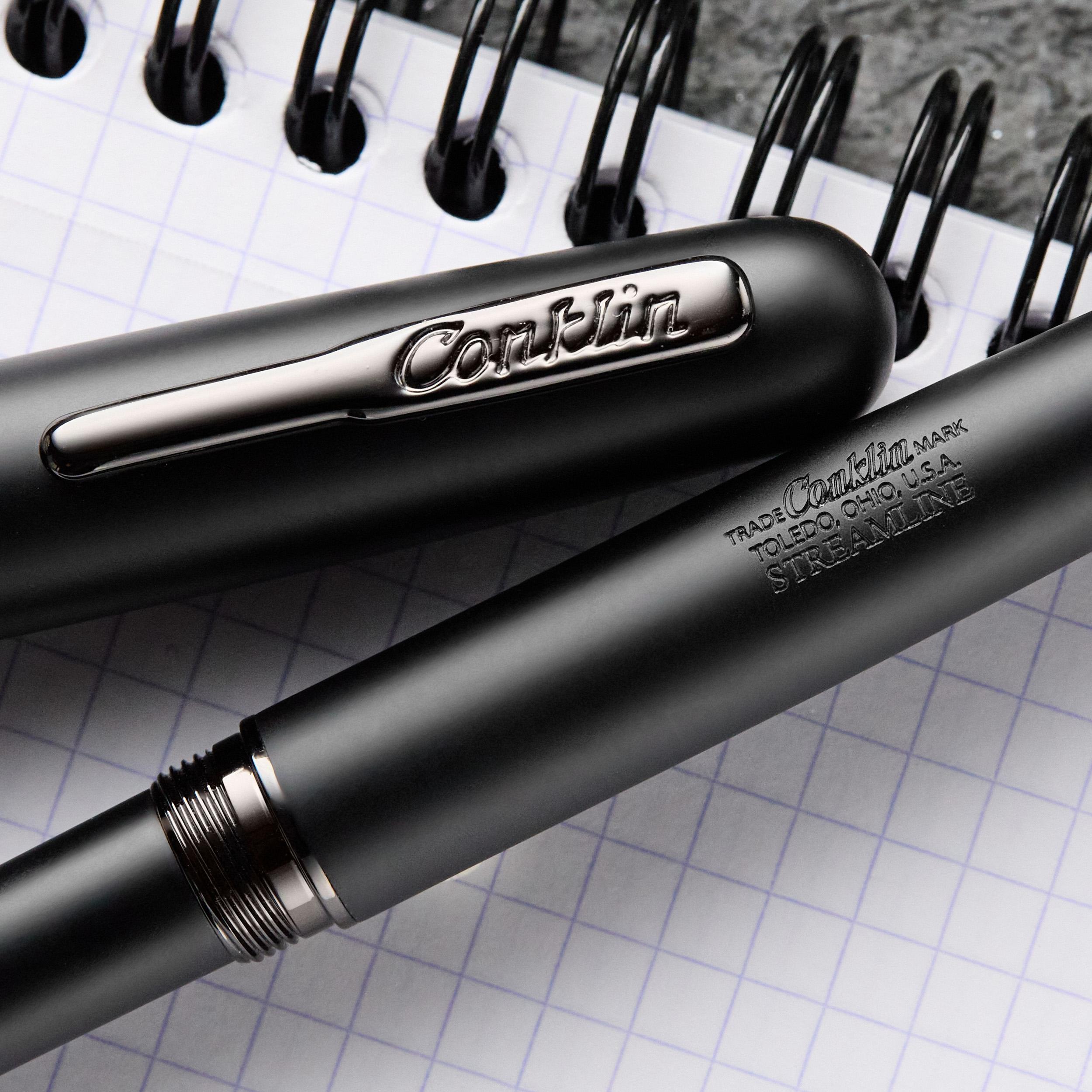 an image of a pen and a notebook with a pen tip