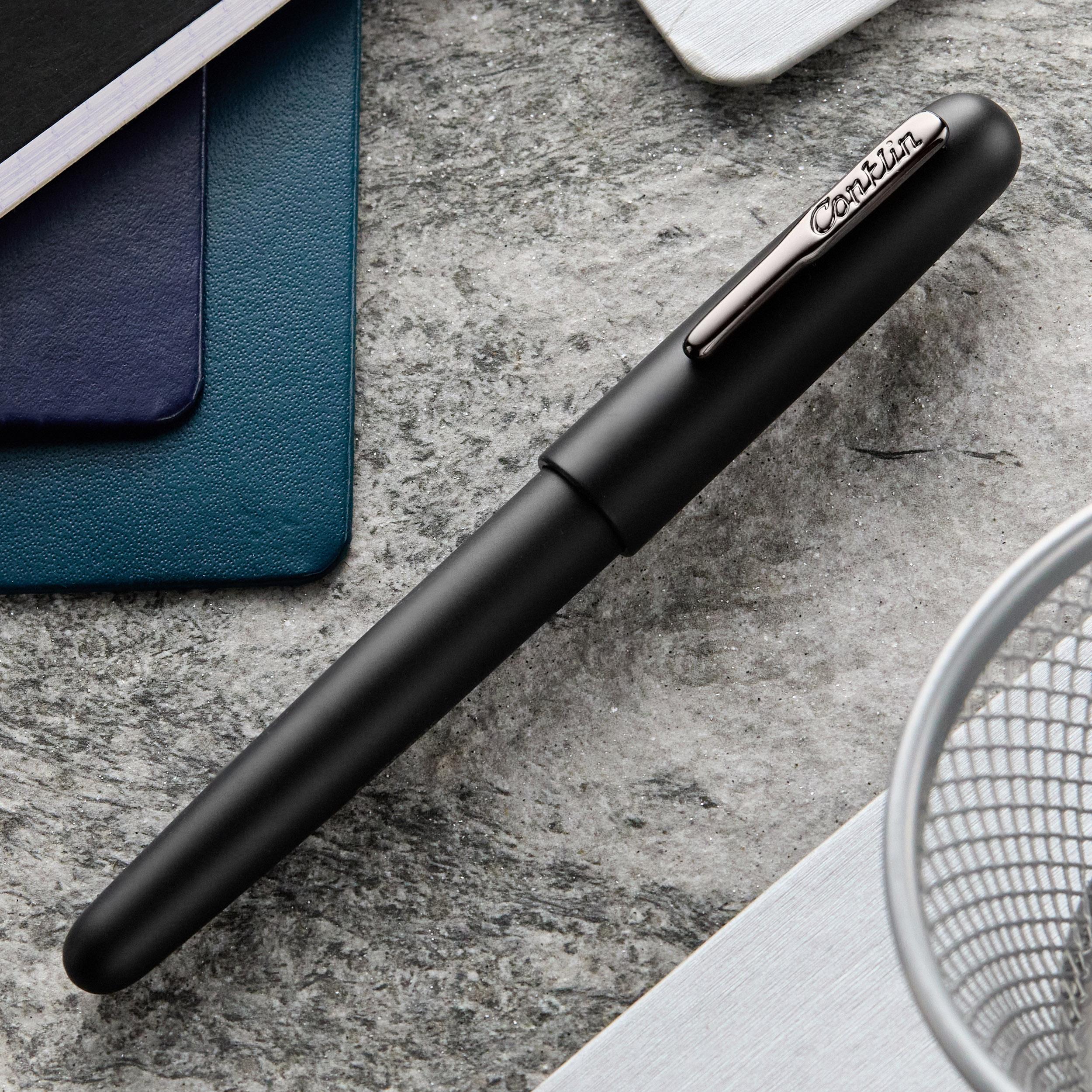 an image of a pen and a notebook on a table