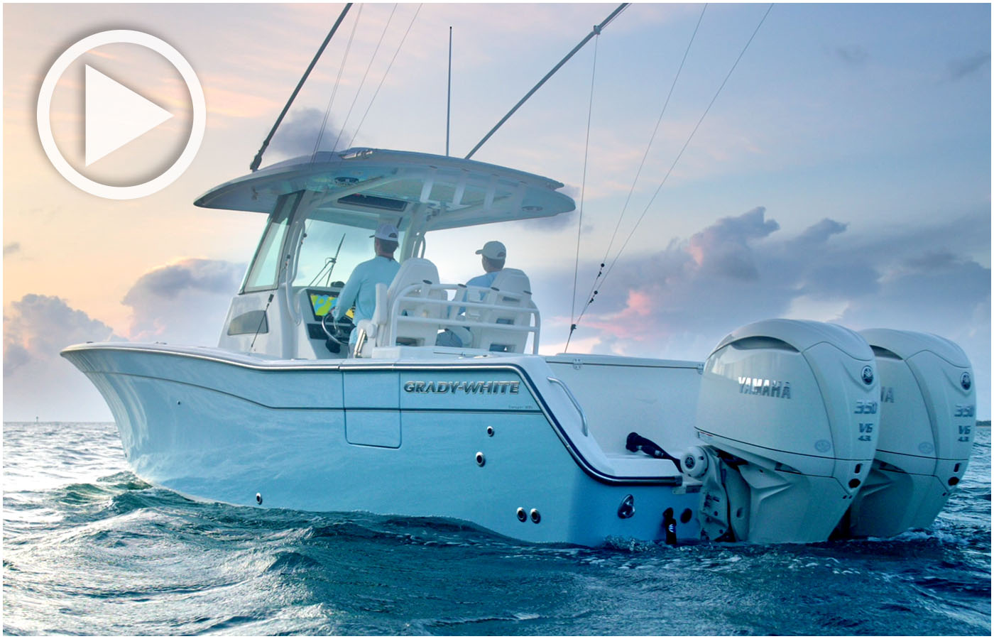 Canyon 306 center console boat cruising port side with two people at helm