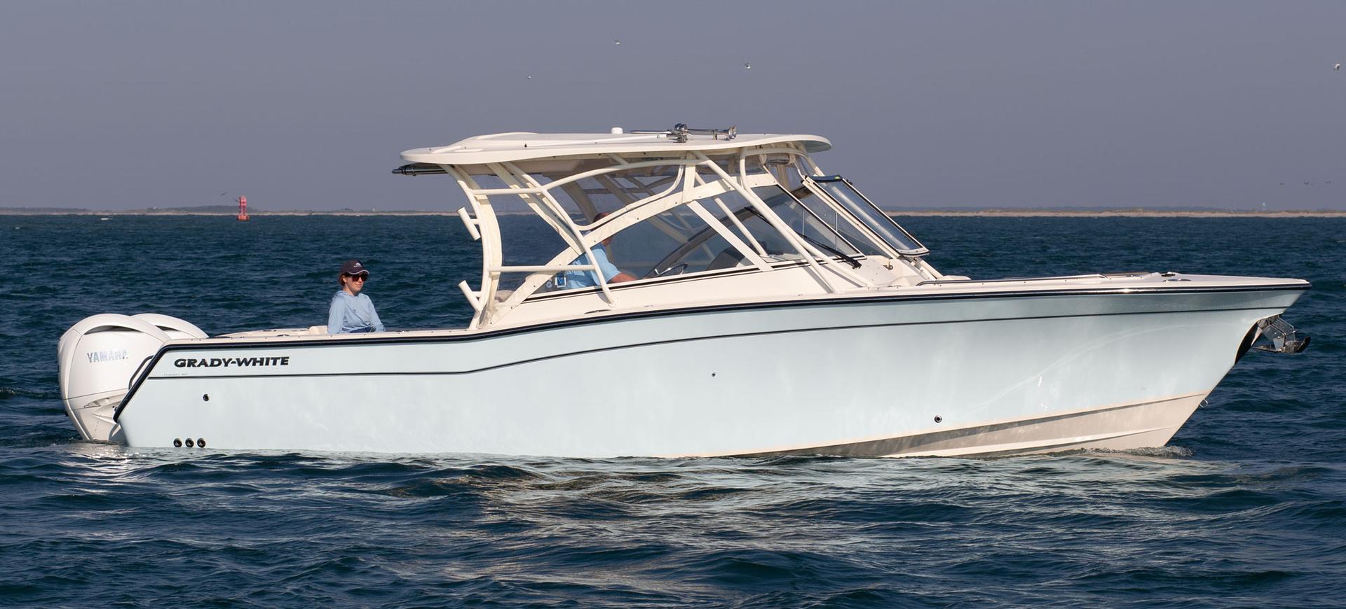 Vinyl curtains being installed on a Grady-White dual console boat