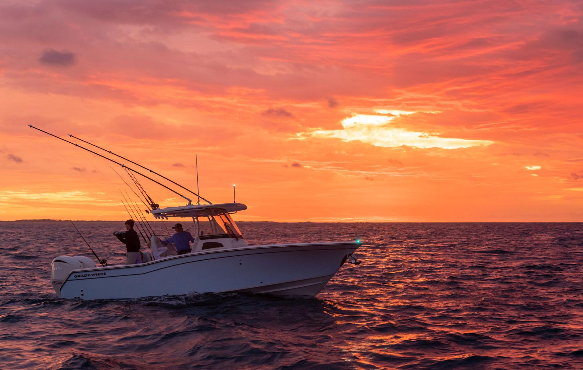Canyon 271 center console boat fishing starboard side with dramatic red sky sunset