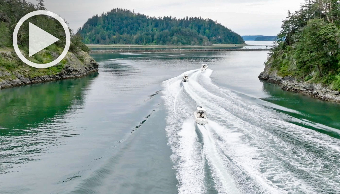 Three Grady-White boats running along the Pacific Northwest coastline