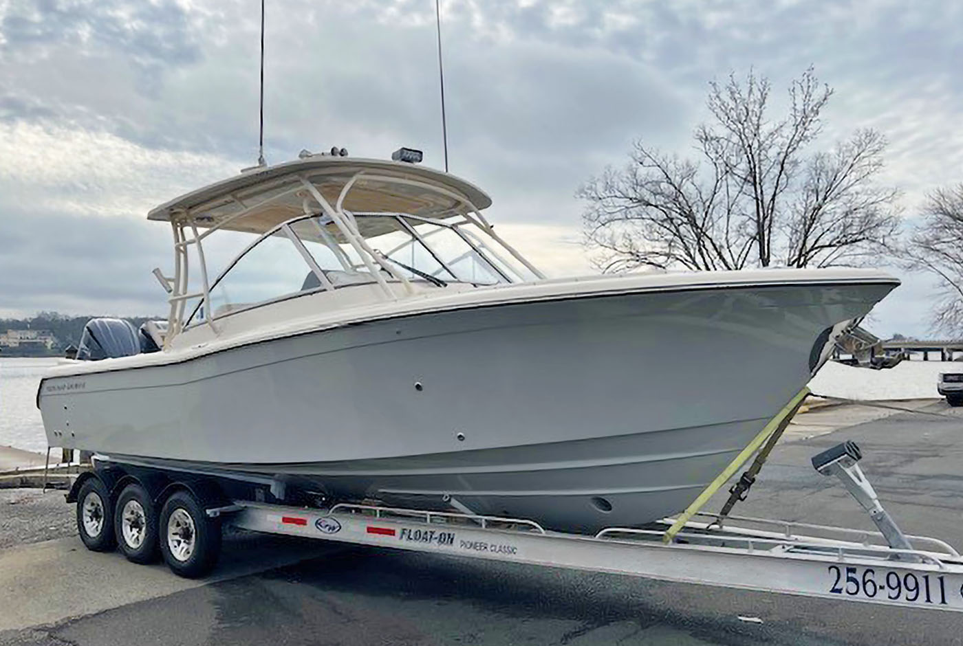 Grady-White Freedom 285 dual console boat on a trailer near a boat ramp
