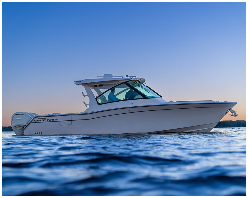 Freedom 345 dual console boat on the water at sunset starboard side