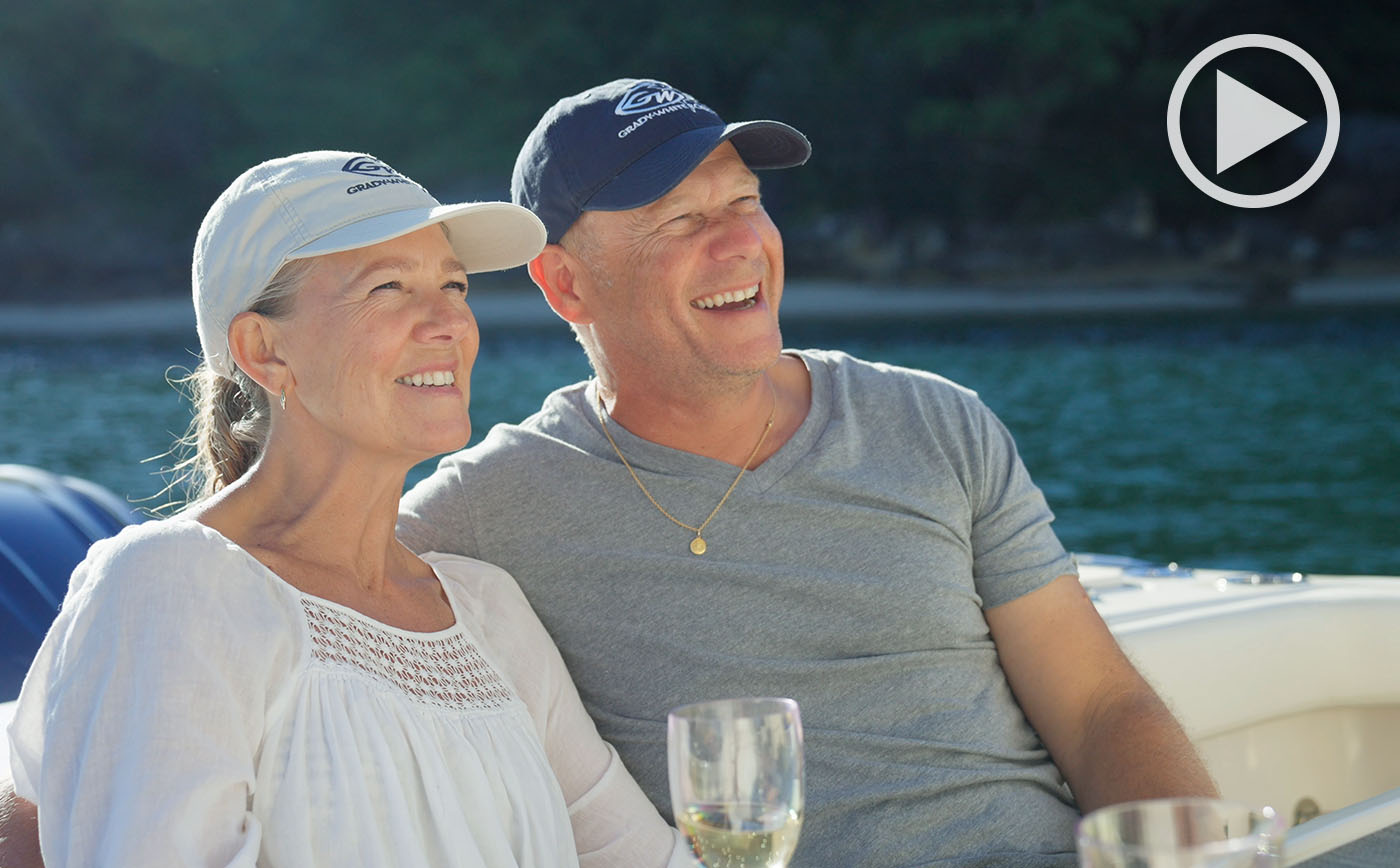 Man and woman relaxing in the cockpit of their Grady-White boat