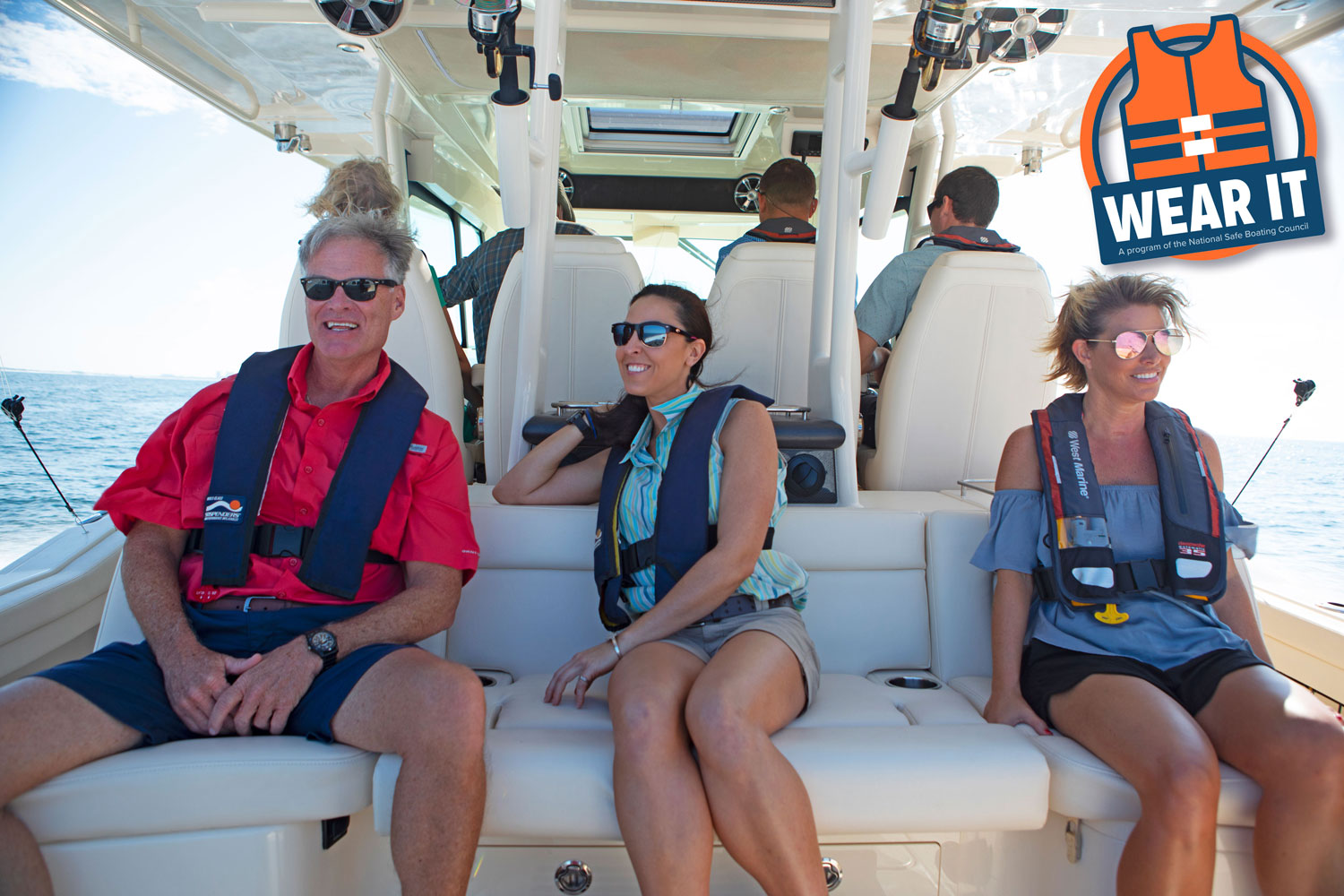 People wearing PFDs while seated on a Grady-White boat