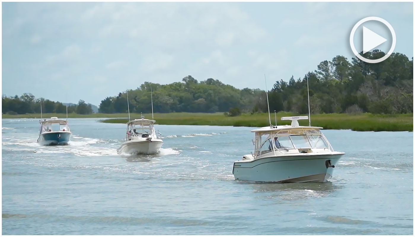 Three Grady-White boats running in a row near shore