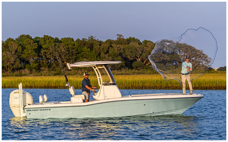Person casting a net from the bow of a Grady-White 251 CE Coastal Explorer