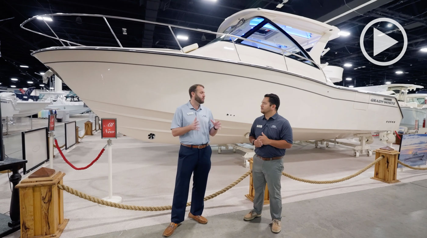 Two men talking in front of the Grady-White Express 340 express cabin boat