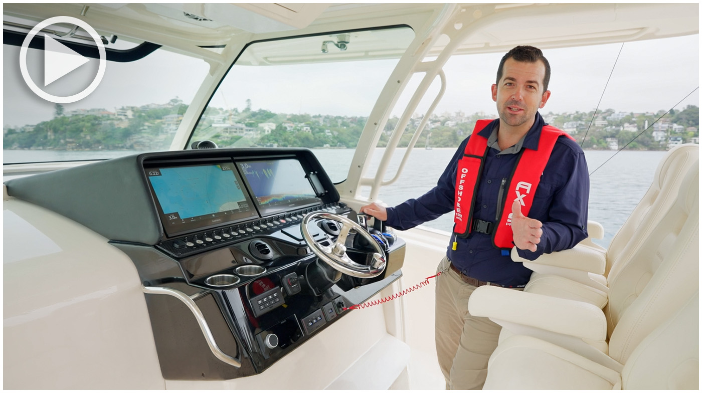 Man operating the binnacle at the helm of a Grady-White Canyon 386 center console boat.