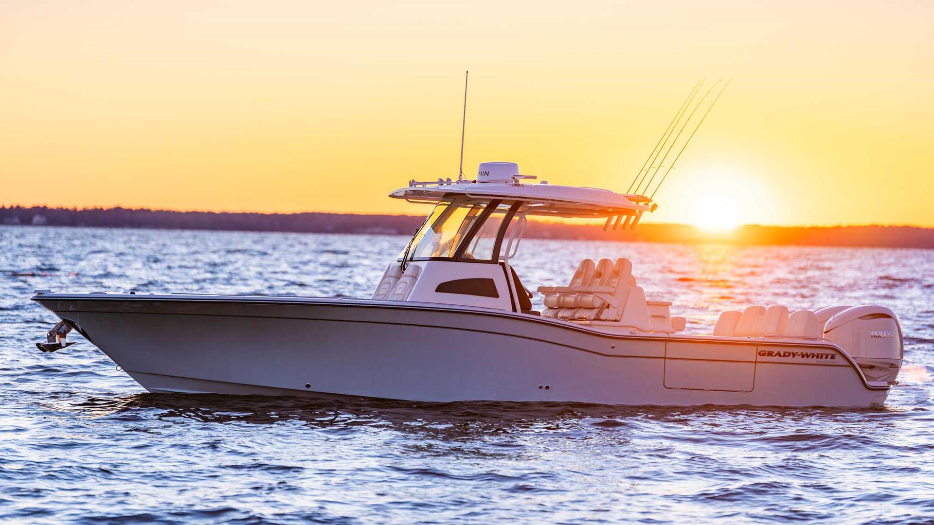 Grady-White 321 Coastal Explorer sitting in open water backlit by the sunrise