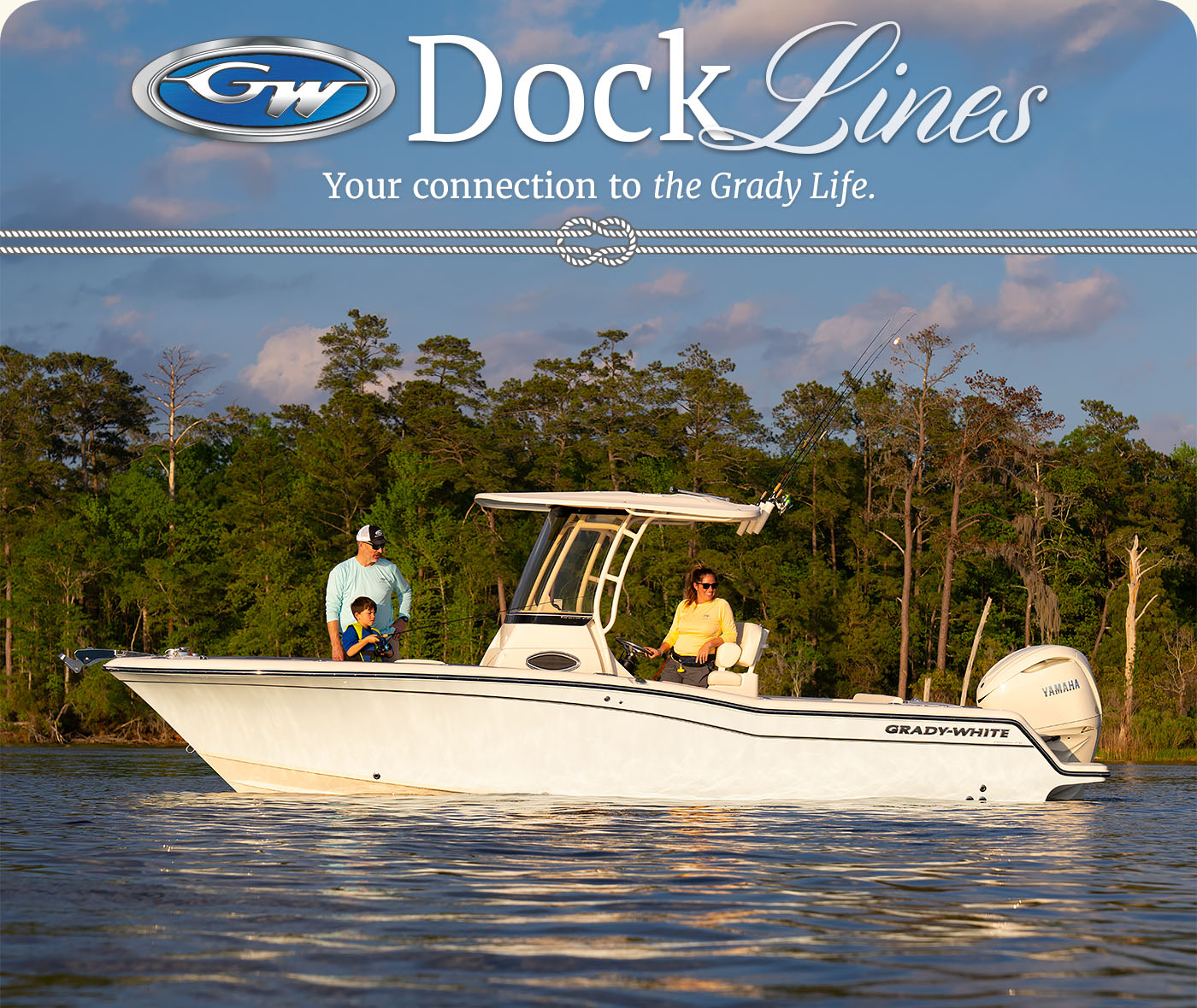 A family aboard a Grady-White Fisherman 236 23-foot center console. The mother is at the helm of the boat watching while the father teaches the son how to fish.