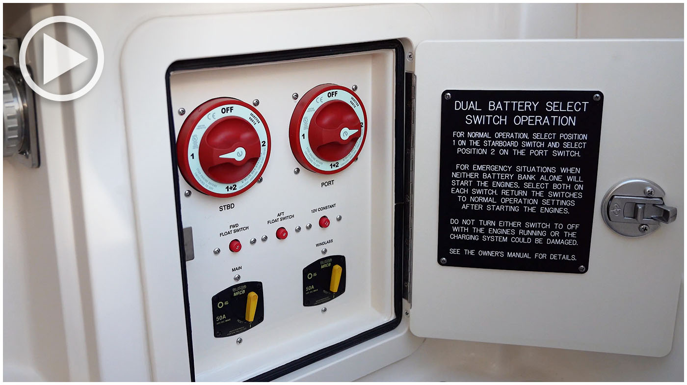 Closeup of the battery select switches on a Grady-White boat. The access door for the switches is open and has instructions printed on the inside.