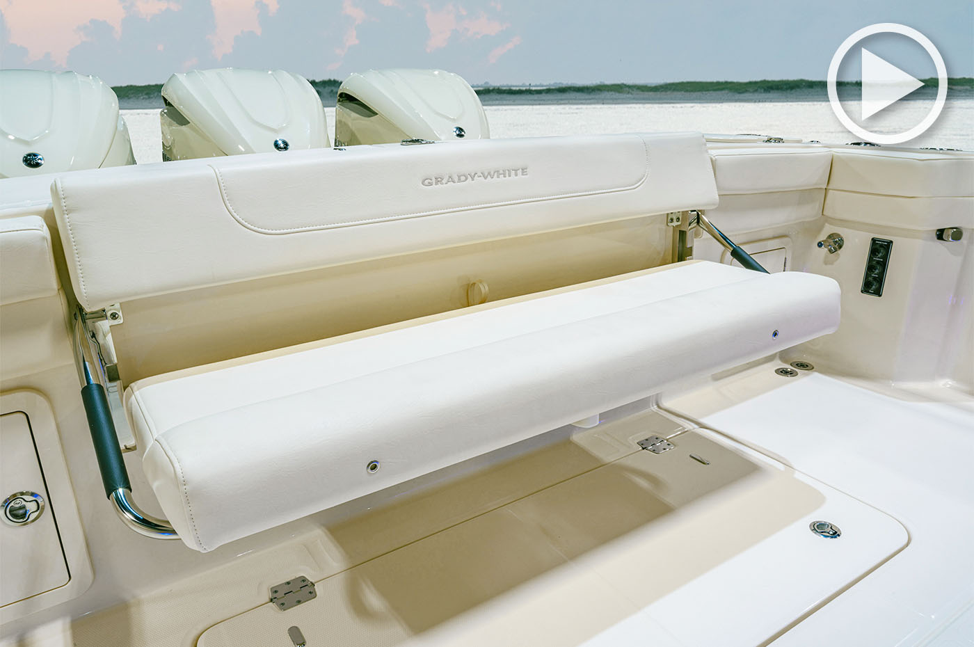 Close-up of the folding aft bench seat in the cockpit of a Grady-White boat shown in the open position.