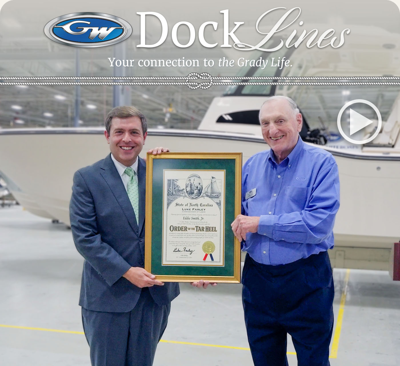 NC Commissioner of Labor Luke Farley and Grady-White Boats owner and CEO Eddie Smith Jr. standing in front of a Grady-White boat.