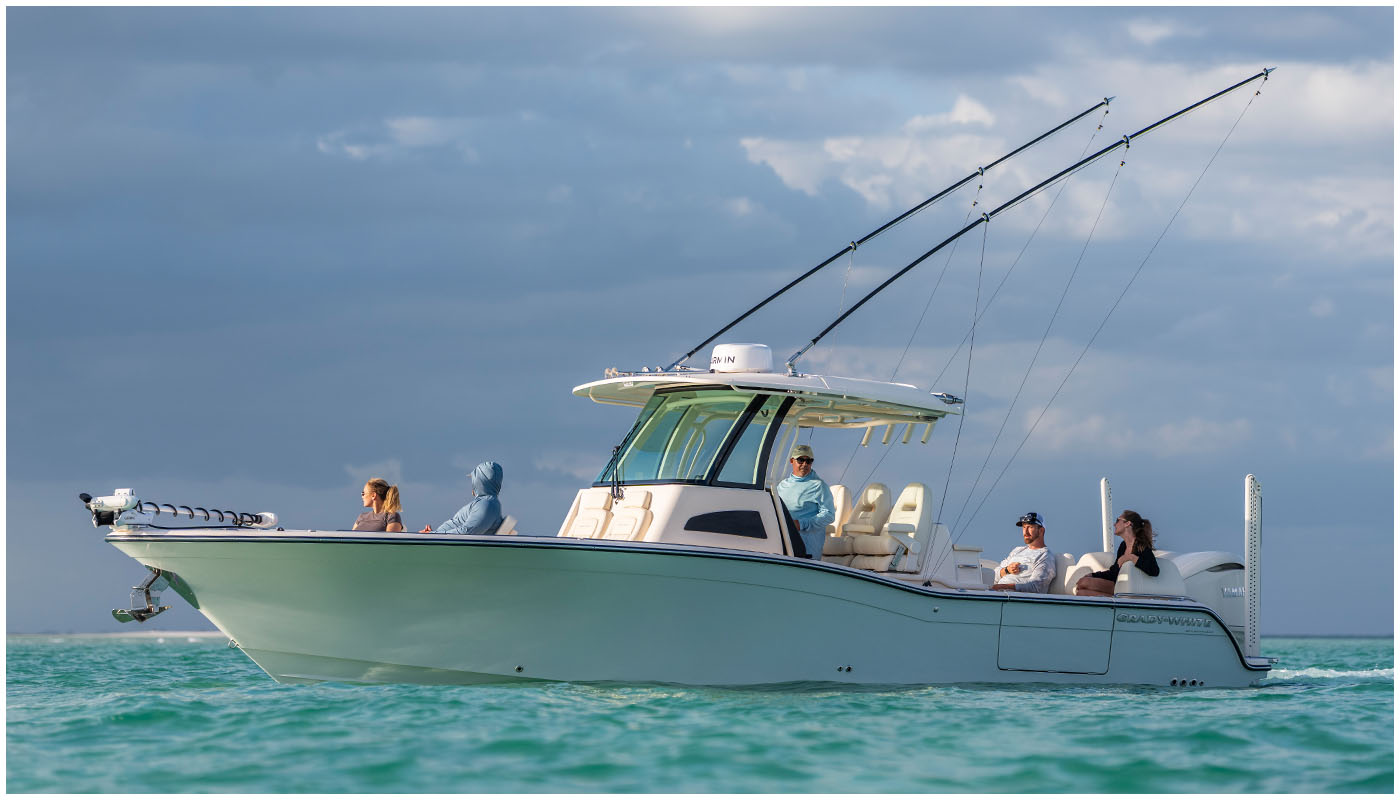 The Grady-White 321 CE cruising on the water with passengers enjoying the bow and cockpit seating under a cloudy sky.