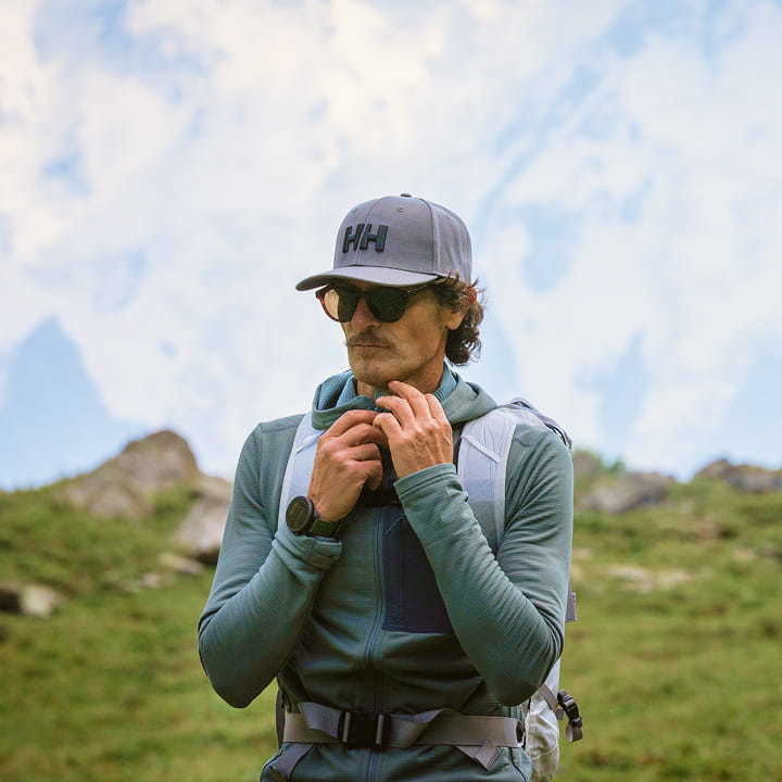 A hiker in Helly Hansen Gear in front of mountains