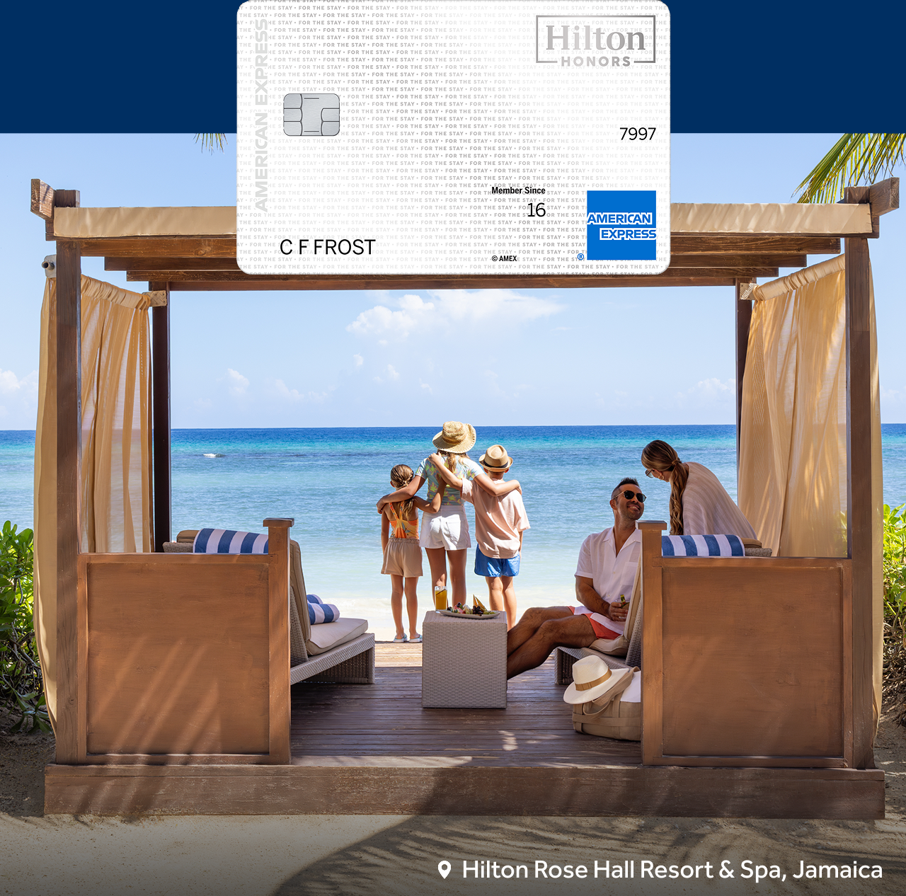 Family at beach cabana with Hilton Honors Amex card above, at Hilton Rose Hall Resort & Spa, Jamaica.