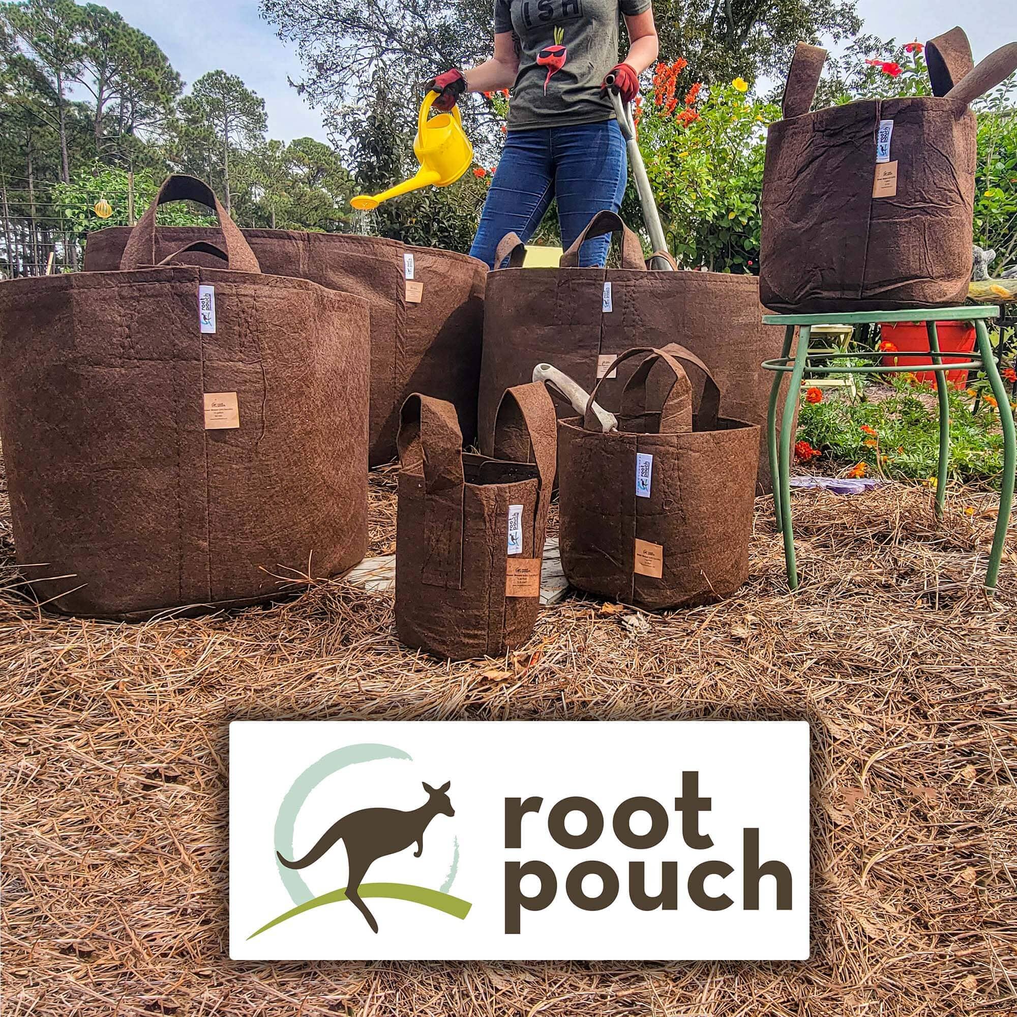 Person watering plants beside various sizes of brown fabric Root Pouch grow bags in a garden.