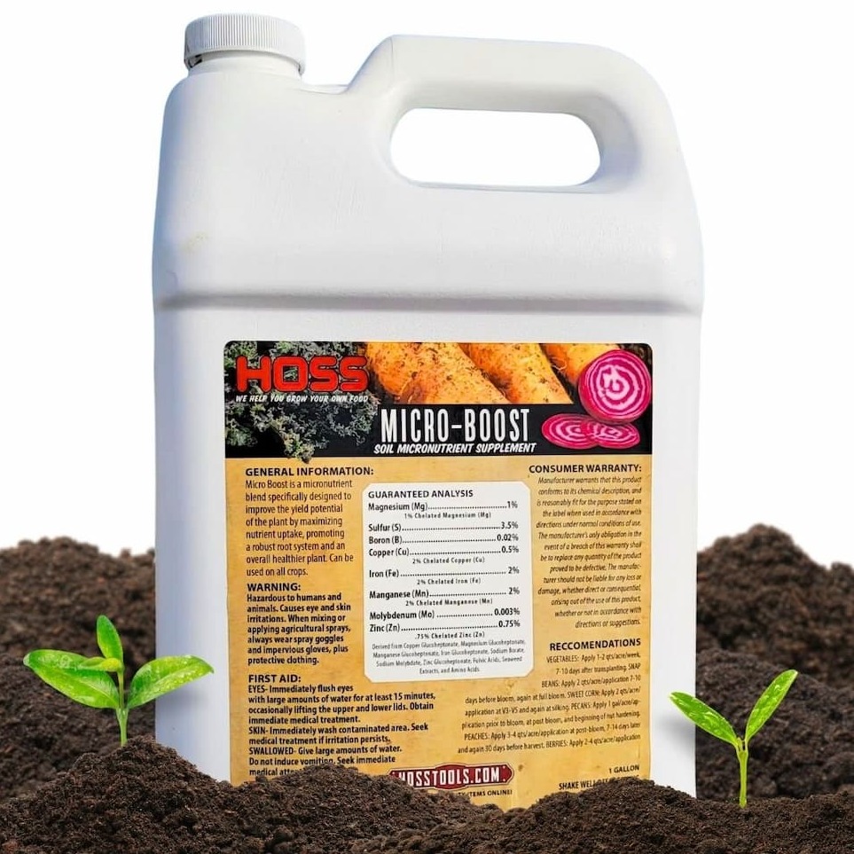 HOSS Micro-Boost soil micronutrient supplement jug placed in soil with small seedlings.